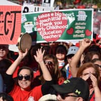 Striking teachers cheer Tuesday in Los Angeles as the teacher union reached a tentative deal with the Los Angeles Unified School District. Union members have to vote on the agreement to end the strike, which started on Jan. 14. | AFP-JIJI