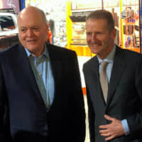 The president and CEO of Ford, Jim Hackett, poses with Volkswagen CEO Herbert Diess at the North American International Auto Show in Detroit on Monday. | REUTERS