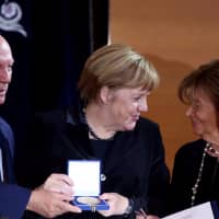 German Chancellor Angela Merkel smiles after she received the Ohel-Jakob award from Rabbi Arthur Schneier (left) and Charlotte Knobloch, president of the central council of Jews in Munich, at the 10th anniversary of the Synagogue in Munich, southern Germany, in 2016. | REUTERS