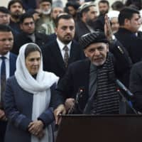 Afghan President Ashraf Ghani speaks to the media as first lady Rula Ghani (left) and Sarwar Danish, his current second vice president, look on at the Independent Electoral Commission office in Kabul on Sunday. | AFP-JIJI