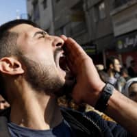 A Syrian kurd shouts slogans during a demonstration in Qamishli on Sunday, marking the first anniversary of the takeover of the northern Syrian city of Afrin by the Turkish army and Turkish-backed Syrian rebels. A bomb exploded in Afrin Sunday, killing three people and wounding nine others, according to a war monitor, on the first anniversary of a Turkish offensive on the Kurdish-majority region. | AFP-JIJI