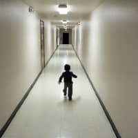 An asylum-seeking boy from Central America runs down a hallway after arriving from an immigration detention center to a shelter in San Diego, California, Dec. 11. The Trump administration expects to launch a policy as early as Friday that forces people seeking asylum to wait in Mexico while their cases wind through U.S. courts, an official said, marking one of the most significant changes to the immigration system of Donald Trump\'s presidency. | AP
