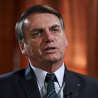 Jair Bolsonaro, Brazil\'s president, speaks during a Bloomberg Television interview on day two of the World Economic Forum (WEF) in Davos, Switzerland, on Wednesday. World leaders, influential executives, bankers and policymakers attend the 49th annual meeting of the World Economic Forum in Davos from Tuesday to Friday. | BLOOMBERG