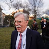 National Security Advisor John Bolton walks on the driveway of the White House after an interview in Washington on Jan. 24. | AFP-JIJI