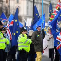 Anti-Brexit protesters demonstrate outside the Houses of Parliament in London Tuesday. | REUTERS