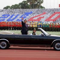 Cambodian Prime Minister Hun Sen, president of the Cambodian People\'s Party, waves during the CPP ceremony to mark the 40th anniversary of the fall of the Khmer Rouge regime at the National Olympic Stadium in Phnom Penh on Jan. 7. | AFP-JIJI