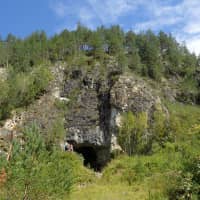 The entrance to Denisova Cave, which contains evidence of previous habitation by an extinct human species, in the Anui River valley in the Altai mountains of Siberia, Russia, is shown in this image released Wednesday. | RICHARD ROBERTS / HANDOUT / VIA REUTERS