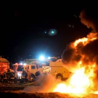 Firefighters work Saturday to extinguish a massive blaze at a leaky pipeline where local residents were collecting fuel in Tlahuelilpan, Mexico. | AFP-JIJI