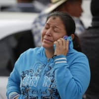 A woman cries outside a funeral service for one of the dozens of victims of the pipeline fire in Tula, Mexico, on Saturday. | AP