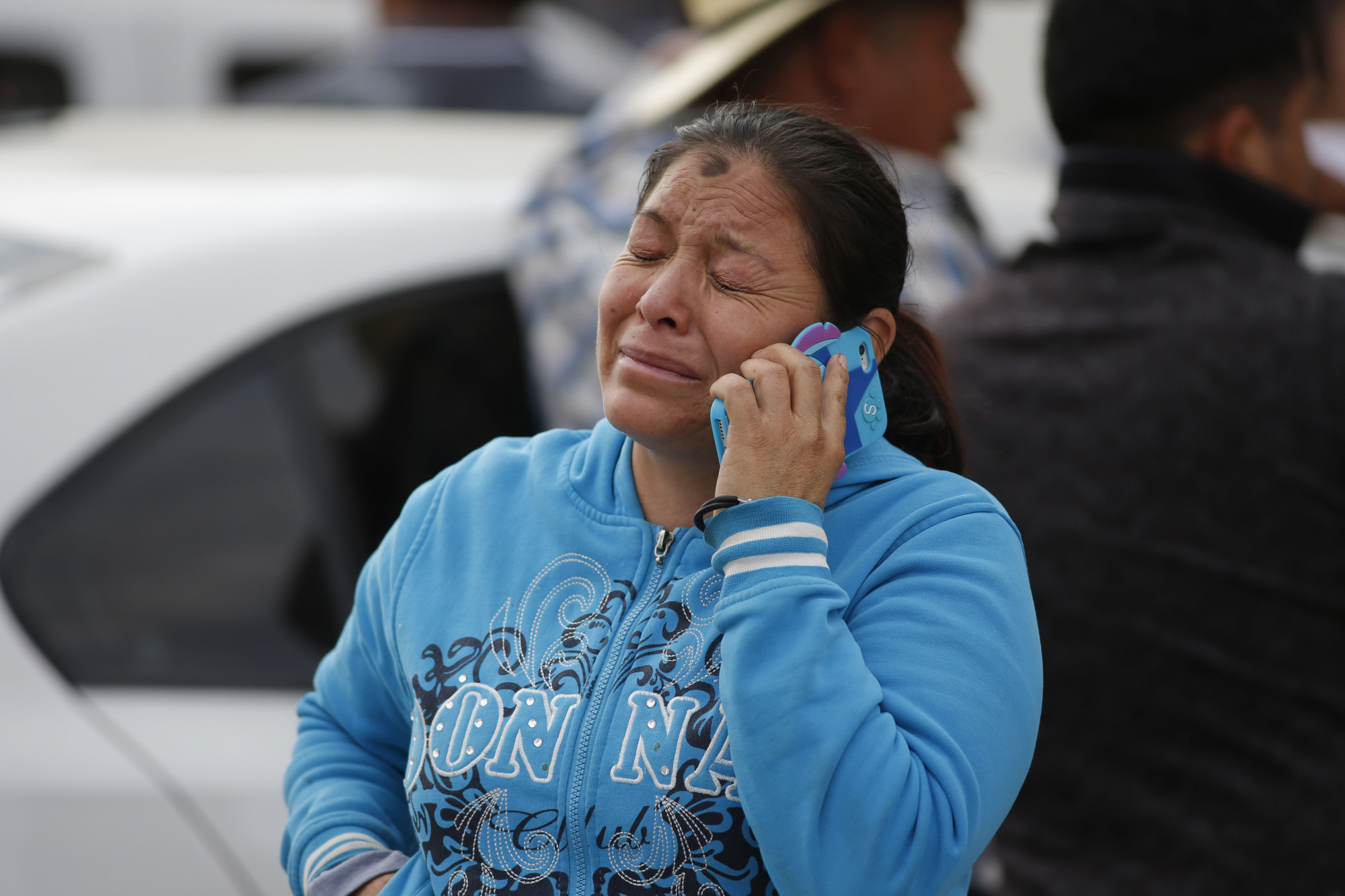 A woman cries outside a funeral service for one of the dozens of victims of the pipeline fire in Tula, Mexico, on Saturday. | AP
