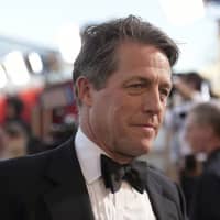 Hugh Grant arrives at the 23rd annual Screen Actors Guild Awards at the Shrine Auditorium &amp; Expo Hall in Los Angeles in 2017. The British actor tweeted a plea to the thief who broke into his car late Sunday: Please return the script that was inside. | RICHARD SHOTWELL / INVISION / VIA AP