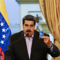 Venezuelan President Nicolas Maduro talks during a meeting with Venezuelan diplomats returning from the U.S., at the Miraflores Presidential Palace in Caracas on Monday. | AFP-JIJI