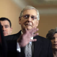 U.S. Senate Majority Leader Mitch McConnell listens as President Donald Trump talks to the media after a Senate Republican policy lunch on Capitol Hill in Washington on Wednesday. | AP