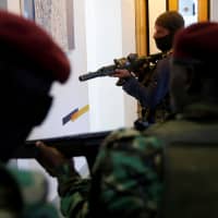 Members of security forces secure a building at the scene where explosions and gunshots were heard at the Dusit hotel compound in Nairobi Jan. 15. | REUTERS