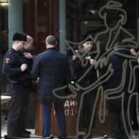 Police officers confer at the Tretyakov State Gallery museum in Moscow on Sunday | AP