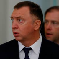 Russian aluminium tycoon Oleg Deripaska and Industry and Trade Minister Denis Manturov arrive for talks involving Russian President Vladimir Putin and South Korean President Moon Jae-in at the Kremlin in Moscow last June. | REUTERS