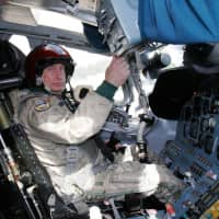Russian strongman Vladimir Putin sits in the cockpit of Tupolev Tu-160 strategic bomber at a military airport outside Moscow in August 2005. The U.S. military said that fighter jets were scrambled after two nuclear-capable Russian Tu-160s entered Canada\'s air defense identification zone on Saturday in the Arctic region near the North American coastline. | AFP-JIJI