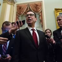 Steven Mnuchin, U.S. Treasury secretary, speaks to members of the media after meeting with Senate Republicans on Capitol Hill in Washington on Tuesday. Mnuchin defended his decision to relax sanctions on three Russian companies linked to oligarch Oleg Deripaska and said he doesn\'t have any immediate plans to agree to an extension for Congress to act. | BLOOMBERG