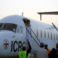 Saudi prisoner Moussa Awaji gestures as he boards an ICRC plane at the Sanaa airport after he was released by the Houthis in Sanaa Tuesday. | REUTERS