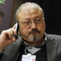 Saudi journalist Jamal Khashoggi speaks on his cellphone at the World Economic Forum in Davos, Switzerland, in 2011. Khashoggi disappeared on Oct. 2 after visiting his country\'s consulate in Istanbul. | AP