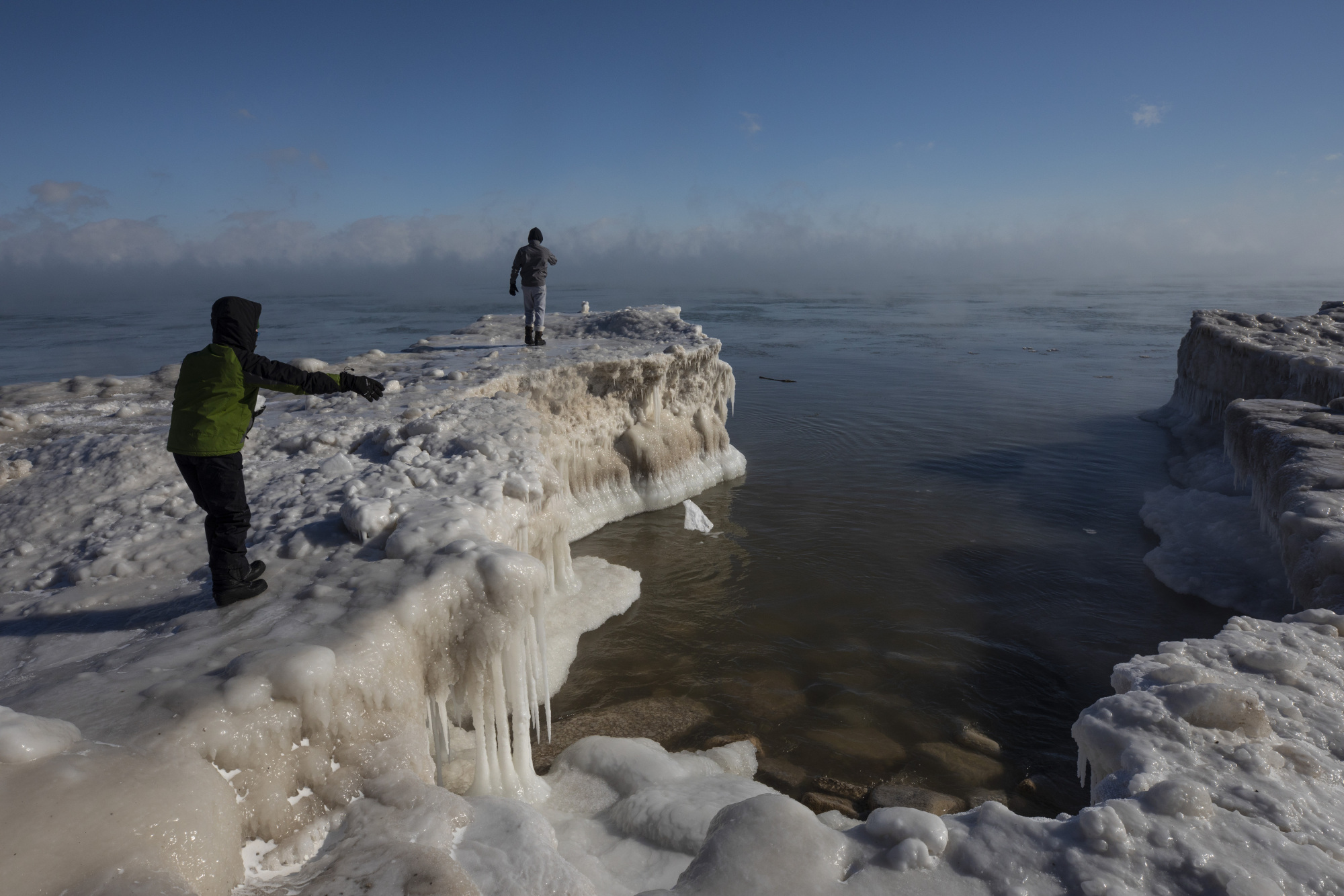 A boy in Milwaukee tosses a chunk of snow into Lake Michigan on Wednesday. | AP