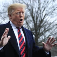 U.S. President Donald Trump speaks to reporters before leaving the White House on Saturday. | AP