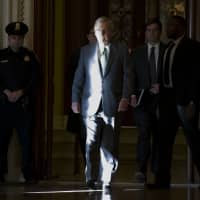 Senate Majority Leader Mitch McConnell walks to his office from the Senate floor on Capitol Hill Tuesday in Washington. | AP