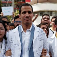 Venezuelan opposition leader and self-proclaimed interim president Juan Guaido takes part in a protest against Venezuelan President Nicolas Maduro\'s government outside the hospital in Caracas Wednesday. | REUTERS