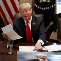 President Donald Trump holds up a letter he says is from North Korean leader Kim Jong Un during a Cabinet meeting at the White House Wednesday in Washington. | AP