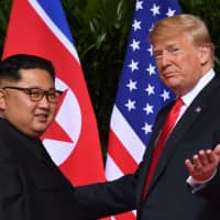 U.S. President Donald Trump gestures as he meets with North Korea\'s leader Kim Jong Un at the start of their summit last June at the Capella Hotel on Sentosa Island in Singapore. Trump and Kim will hold a summit \"near the end of February,\" the White House said on jan. 18, without specifying the location. | AFP-JIJI