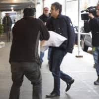 Michael Cohen arrives at his home in New York with his left arm in a sling supported by a pillow Friday. Democrats are vowing to investigate whether President Donald Trump directed Cohen, his personal attorney, to lie to Congress about a Moscow real estate project, calling that possibility a \"concern of the greatest magnitude.\" | AP