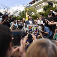 Juan Guaido speaks during a rally to propose amnesty laws for police and military members in Caracas on Saturday. | BLOOMBERG