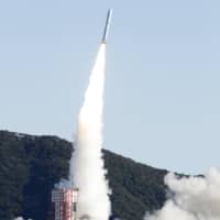 An Epsilon-4 rocket lifts off from Uchinoura Space Center in Kagoshima Prefecture on Friday morning. | KYODO