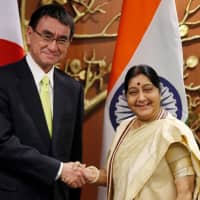 Foreign Minister Taro Kono shakes hands with his Indian counterpart, Sushma Swaraj, before the start of their meeting in New Delhi on Monday. | REUTERS