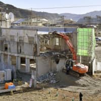 Work to demolish the former town hall, where dozens of people died when it was hit by the March 11, 2011, tsunami, begins in Otsuchi, Iwate Prefecture, on Saturday. Some residents wanted the building to be preserved as a memorial. | KYODO