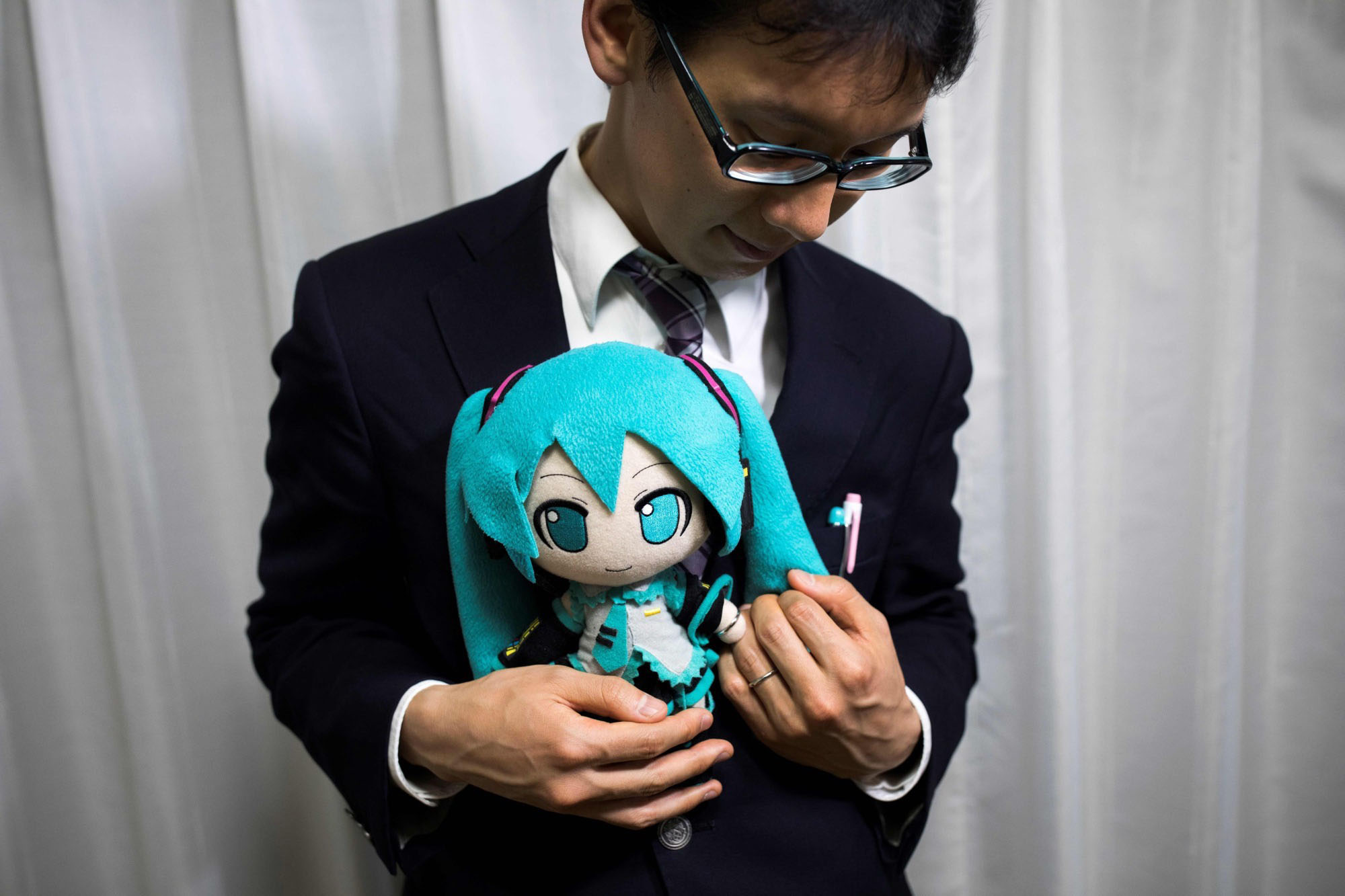 Akihito Kondo with a figurine of his 