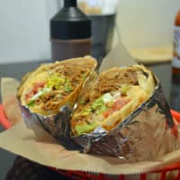 Well-stuffed: Que Pasa\'s king-size burrito is filled with beans, cheddar cheese, American-grown rice and succulent pork. | J.J. O\'DONOGHUE