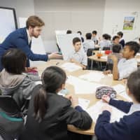 Asking the right questions: Alexander Dutson (left) teaches a class of returnee junior high school students at Kaetsu Ariake in Tokyo. That day\'s particular lesson was on personal identity and the children were discussing whether they think they remain the same person over time. | &#169; THE RELATIVE WORLDS