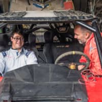 Jacques Barron (right) and his son and co-driver Lucas Barron are seen in December in Lima, where their car is being prepared to take part in the upcoming Dakar Rally. | AFP-JIJI