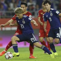 Japan\'s Ritsu Doan controls the ball in front of Vietnam\'s Do Hung Dung during their Asian Cup quarterfinal match on Thursday at Al Maktoum Stadium in Dubai, United Arab Emirates. Japan won 1-0 to advance to the semifinals. | AP