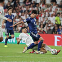 A smart play by Takumi Minamino (right) led to Japan\'s first goal over Iran on Monday during its 3-0 Asian Cup semifinal win in Al Ain, United Arab Emirates. | AFP-JIJI