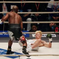 Tenshin Nasukawa (right) is knocked down by Floyd Mayweather Jr. in the first round of their New Year’s Eve exhibition at Saitama Super Arena. | REUTERS