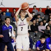 Sakuragaoka Gakuen High School\'s Keisei Tominaga launches a 3-point shot during last month\'s Winter Cup national championship in Tokyo. | KAZ NAGATSUKA