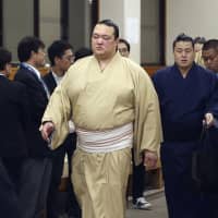 Yokozuna Kisenosato leaves Ryogoku Kokugikan on Sunday after his defeat to Mitakeumi on the first day of the New Year Grand Sumo Tournament. | KYODO