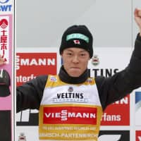Ryoyu Kobayashi celebrates on the podium after winning a World Cup event on Tuesday in Garmisch-Partenkirchen, Germany. | KYODO