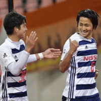 F. Marinos midfielder Kosuke Nakamachi (right) celebrates after scoring a goal against Albirex in Levain Cup action on April 4 in Niigata. The 33-year-old announced his plans to join a club in Zambia on Wednesday. | KYODO