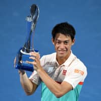 Kei Nishikori celebrates with the winner\'s trophy after defeating Daniil Medvedev of Russia in the men\'s singles final match at the Brisbane International on Sunday. | AFP-JIJI