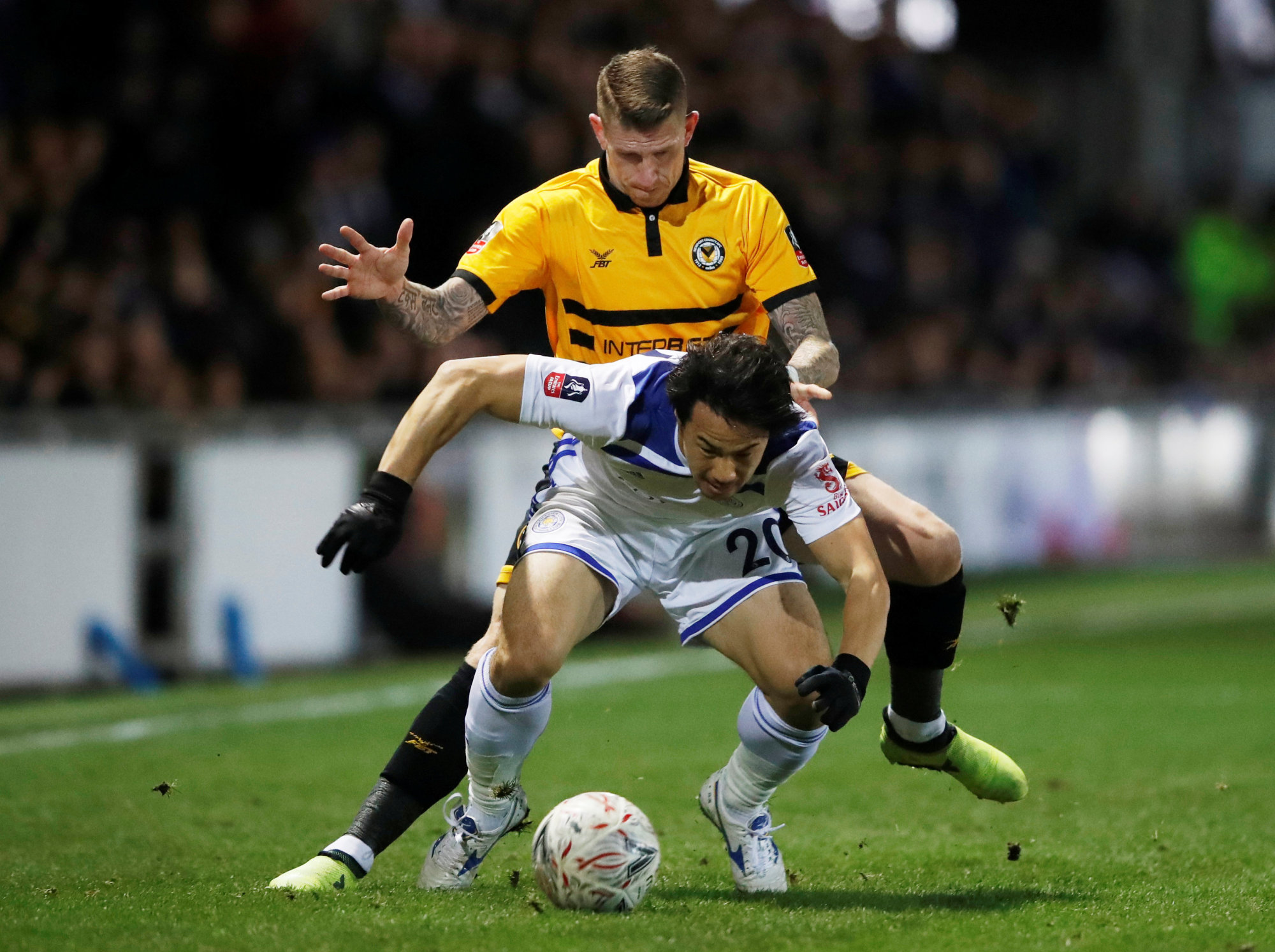 Leicester's Shinji Okazaki (front) fights with with Newport County's Scott Bennett for the ball on Jan. 6 in Rodney Parade, England. The Samurai Blue veteran has expressed his willingness to change clubs in the current transfer window if it improves his chances of participating in the next World Cup. | REUTERS