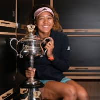 Naomi Osaka poses with the trophy after winning the Australian Open on Saturday in Melbourne, Australia. | AFP-JIJI