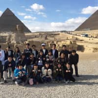 The group poses for a photo in front of the Great Sphinx of Giza and the pyramids during their stay in Egypt. | COURTESY OF THE EGYPTIAN EMBASSY